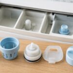 洗濯機の洗剤投入口と複数の交換用キャップを並べたイメージ